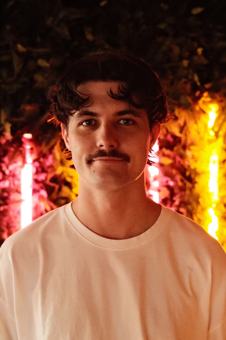 Portrait of Jayden Davies in warm venue lighting
